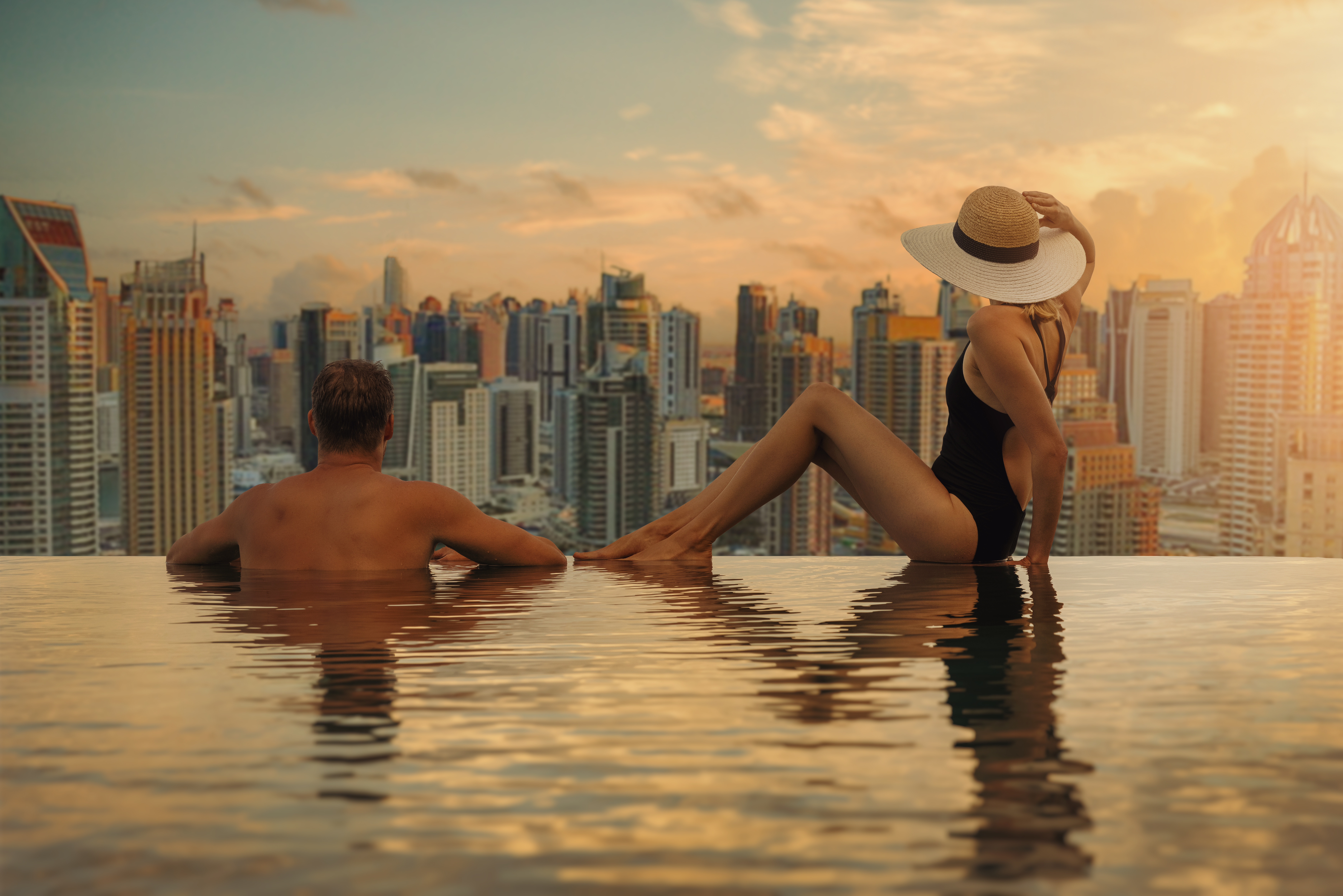 Luxury travel — rooftop infinity pool at golden hour